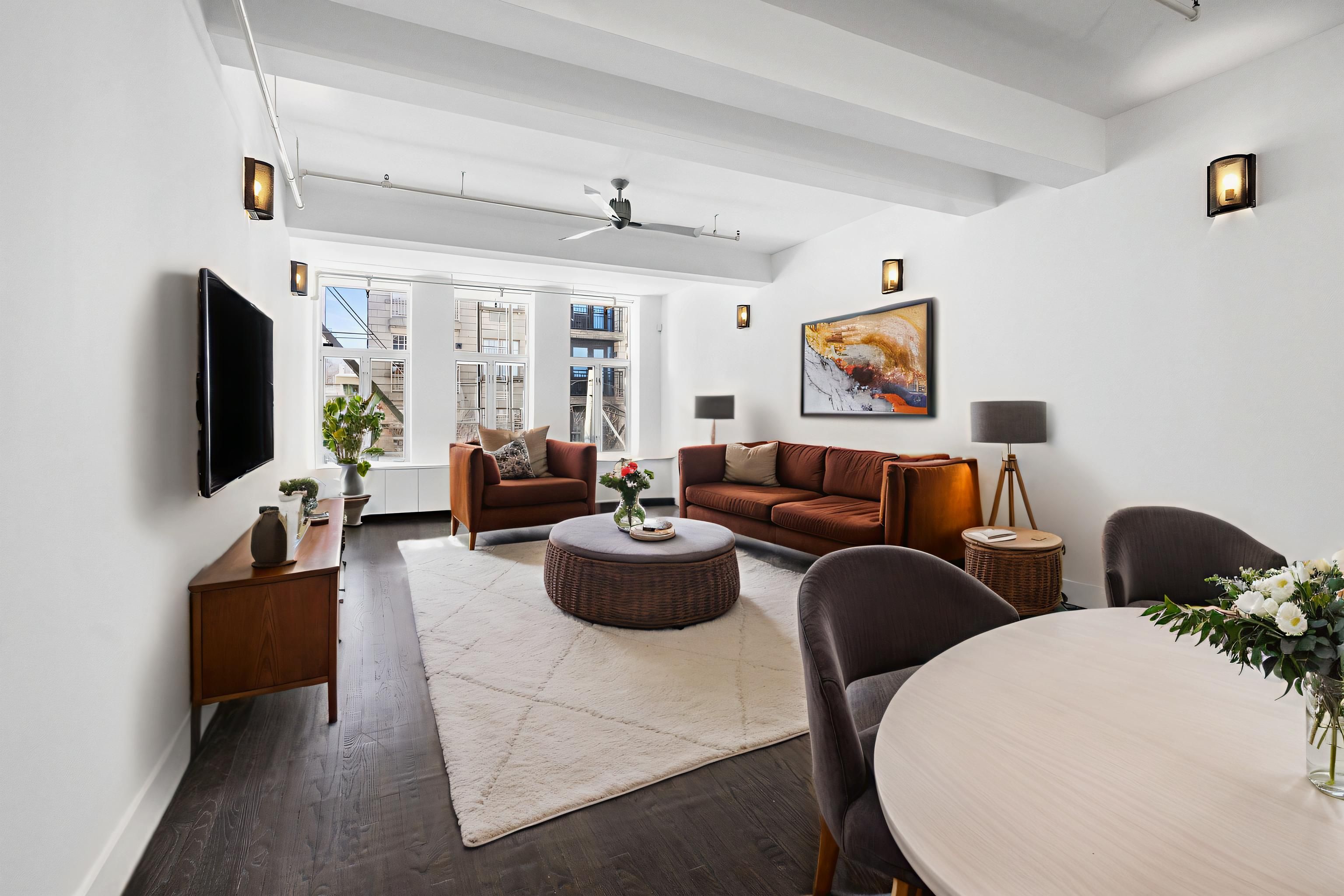 91 Grand Avenue, Unit 2D Brooklyn, NY 11205 - Photo 2 of 16 a living room with furniture a flat screen tv and a window