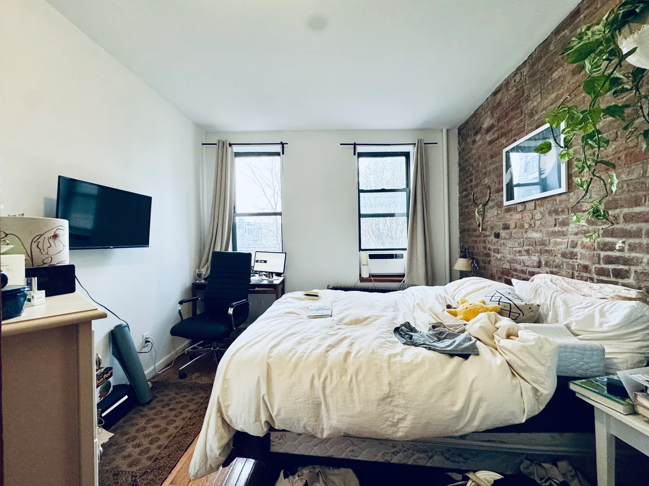 a bedroom with a bed and a flat screen tv