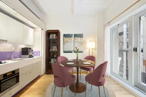 a view of a dining room with furniture and window