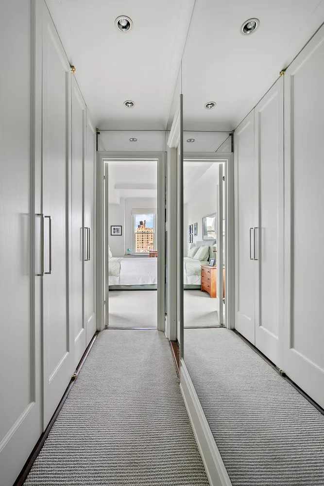 a view of a hallway with wooden shelves