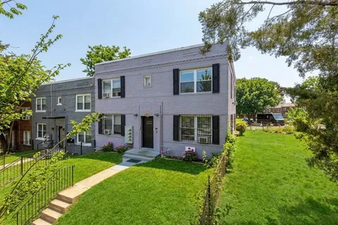 a view of a house with a yard and plants