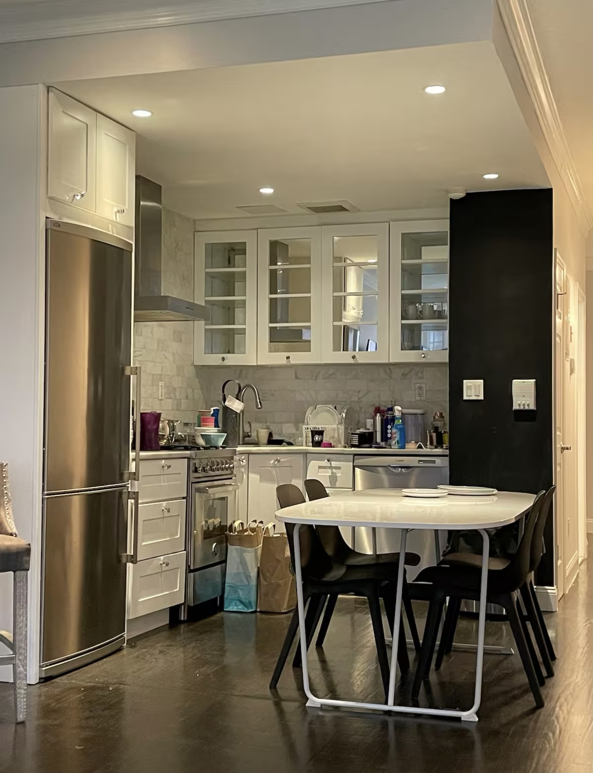 2073 Adam Clayton Powell Jr Boulevard, Unit 4 Manhattan, NY 10027 - Photo 5 of 10 a kitchen with stainless steel appliances granite countertop a dining table chairs refrigerator and sink