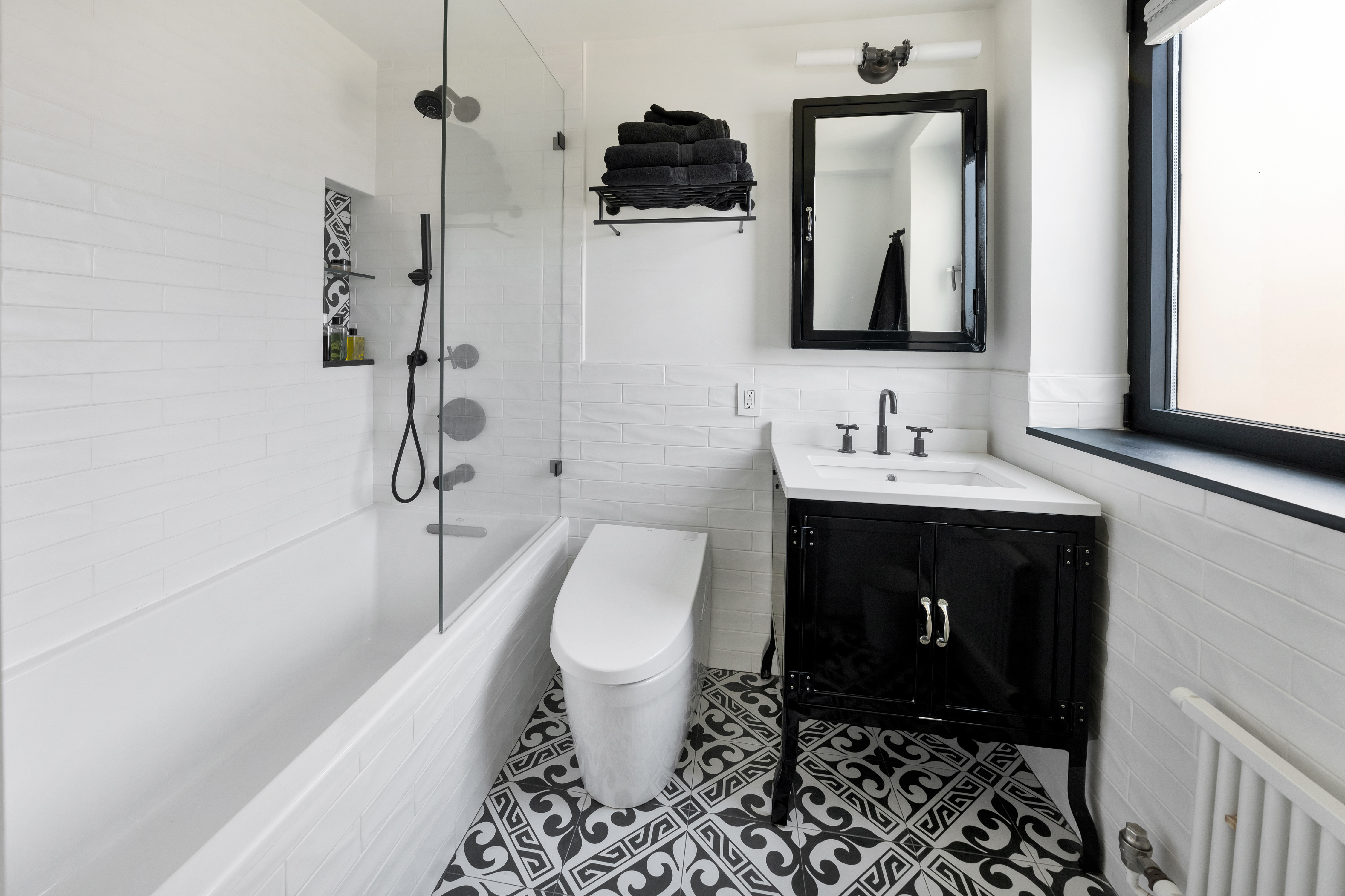 400 East 52nd Street, Unit 14J Manhattan, NY 10022 - Photo 9 of 11 a bathroom with a toilet sink and mirror
