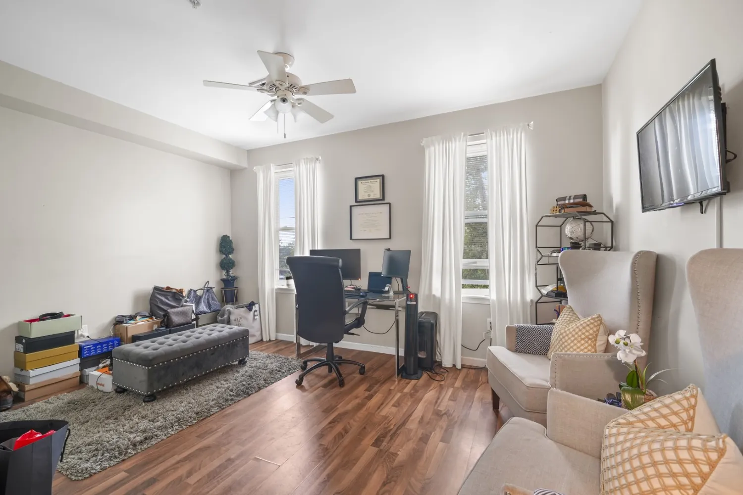 a bedroom with a bed and a painting on the wall