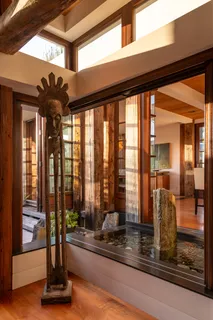 a view of a patio with table and chairs under an umbrella with a small yard