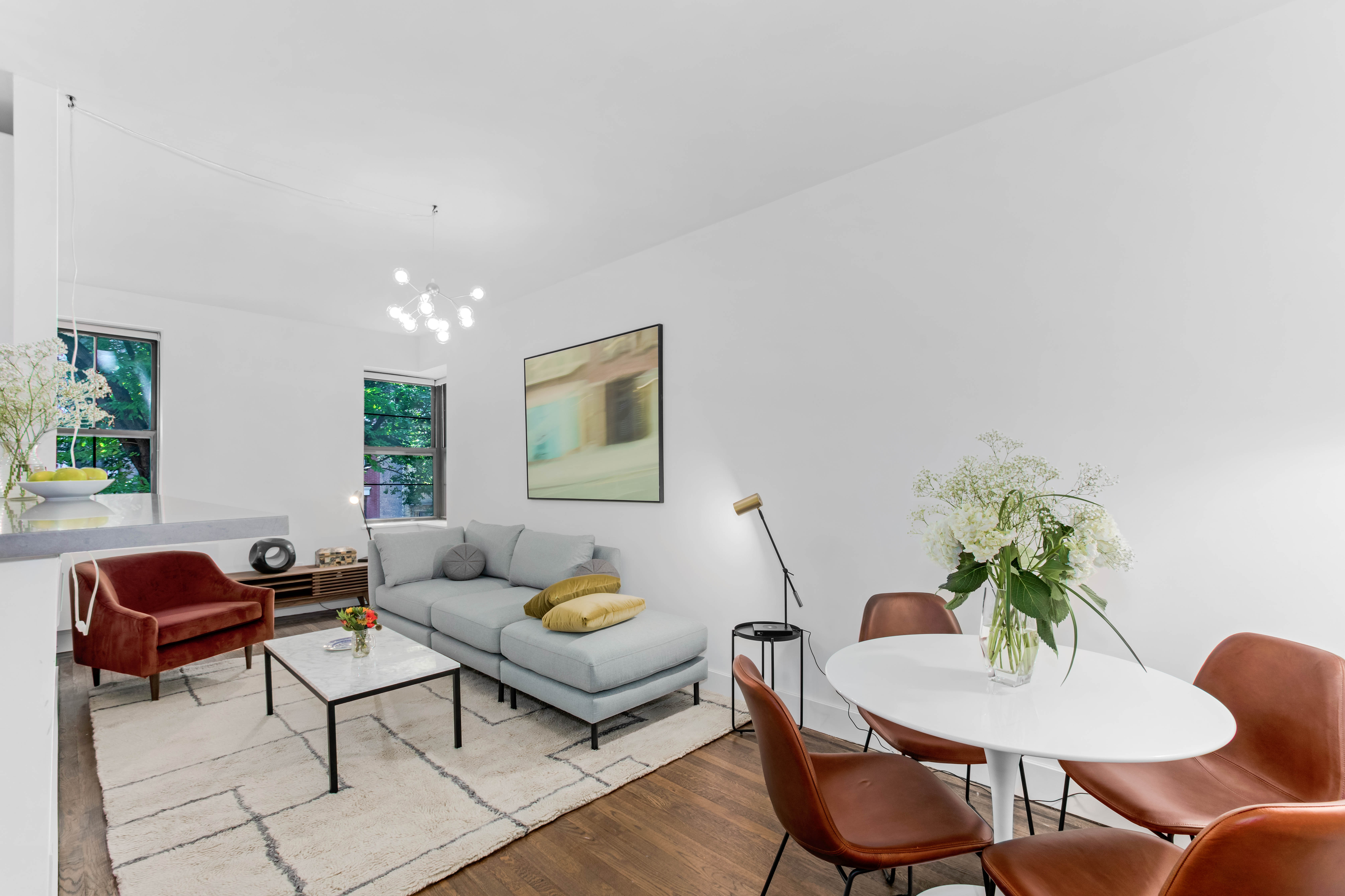 245 West 25th Street, Unit 3F Manhattan, NY 10001 - Photo 1 of 13 a living room with furniture and a potted plant