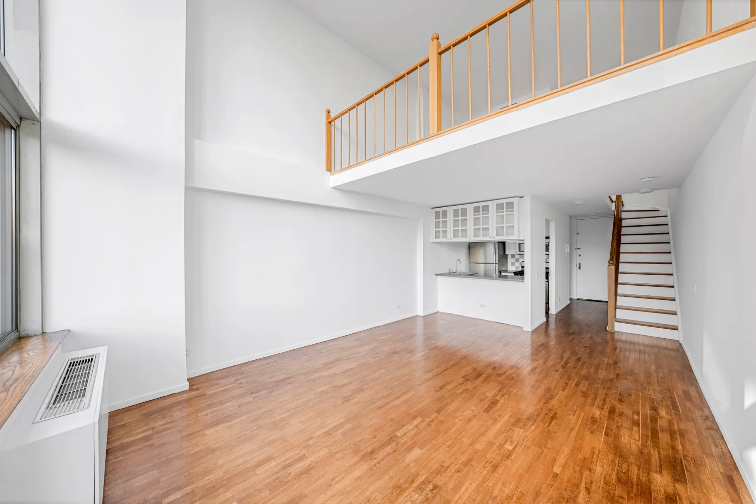 a view of empty room with wooden floor