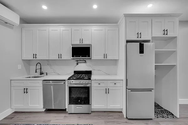 30 Marconi Place, Unit 2 Brooklyn, NY 11233 - Photo 3 of 11 a kitchen with stainless steel appliances a stove a sink and a refrigerator