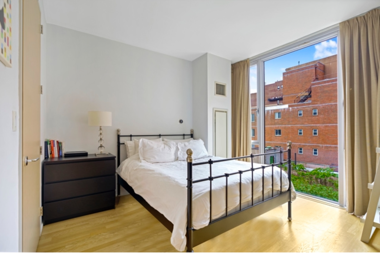 110 3rd Avenue, Unit 9B Manhattan, NY 10003 - Photo 7 of 14 a bed room with a bed and a painting on the wall