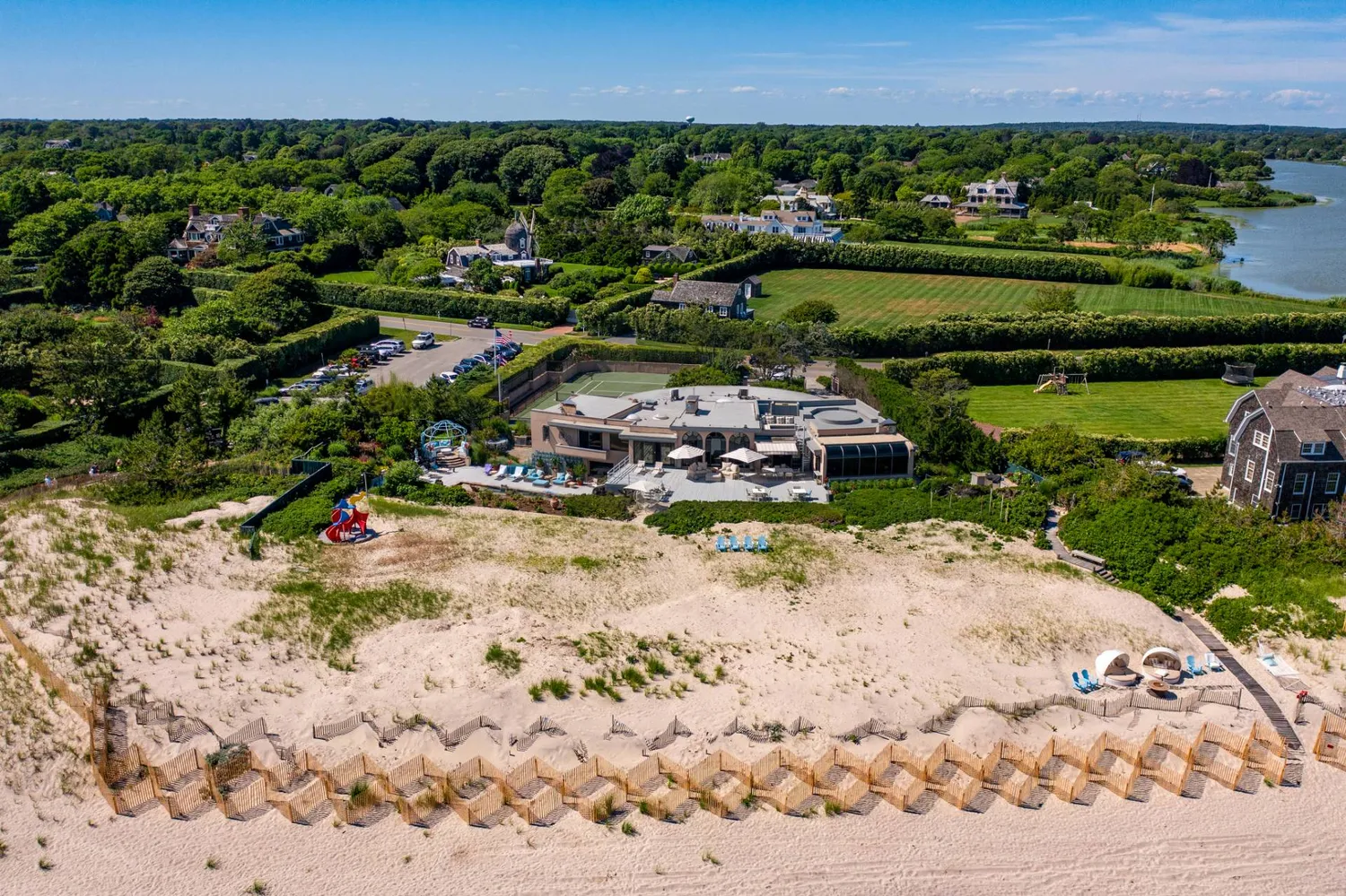 an aerial view of a house with a yard and lake view