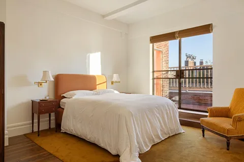 a bedroom with a bed and a table