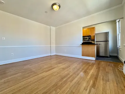 a view of a kitchen with a sink and a refrigerator
