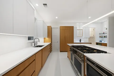 a kitchen with stainless steel appliances a sink dishwasher stove and refrigerator