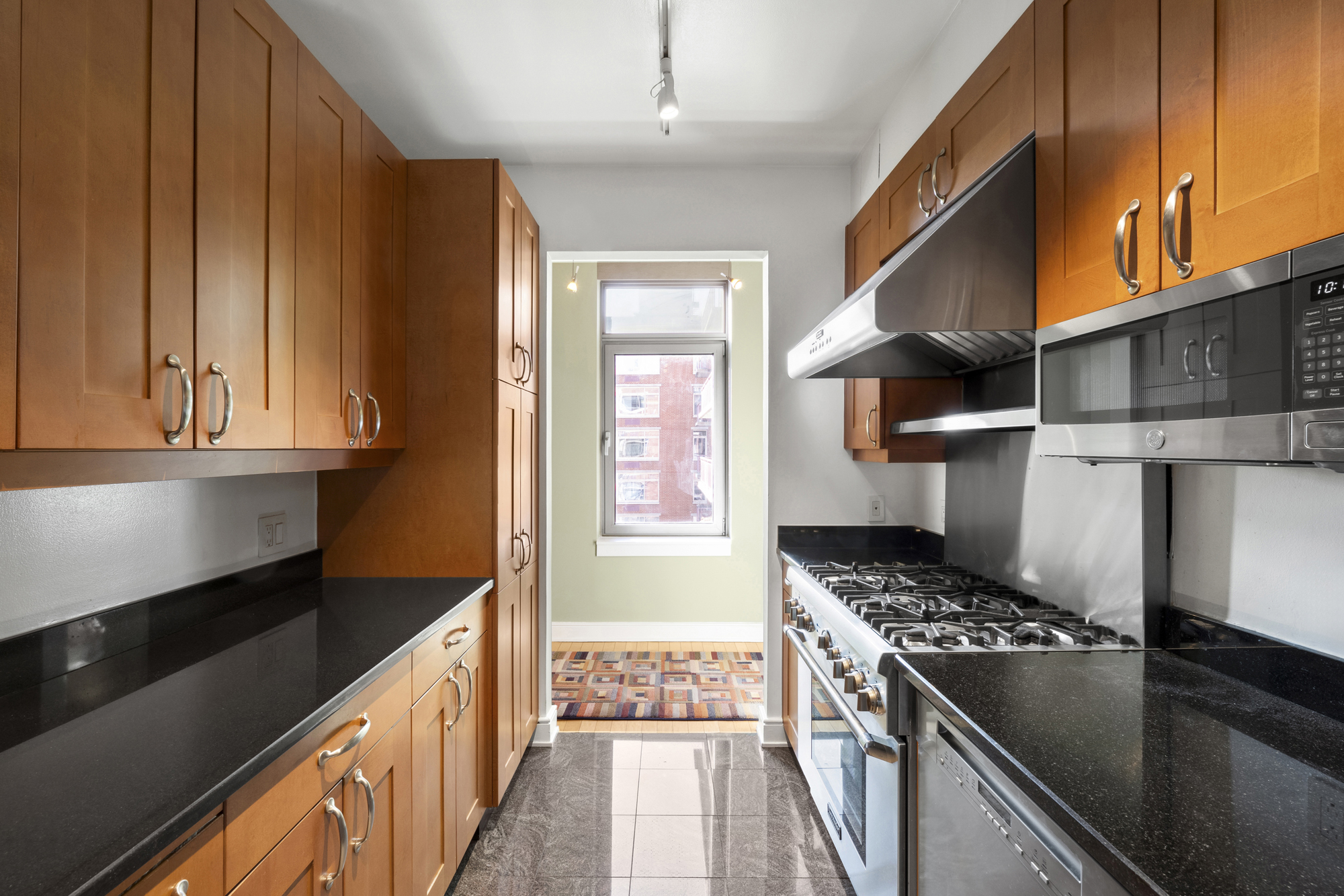 99 Jane Street, Unit 4H Manhattan, NY 10014 - Photo 7 of 22 a kitchen with a stove and a refrigerator