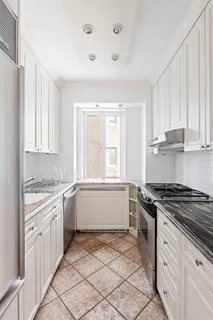 a kitchen with a stove a sink and a refrigerator