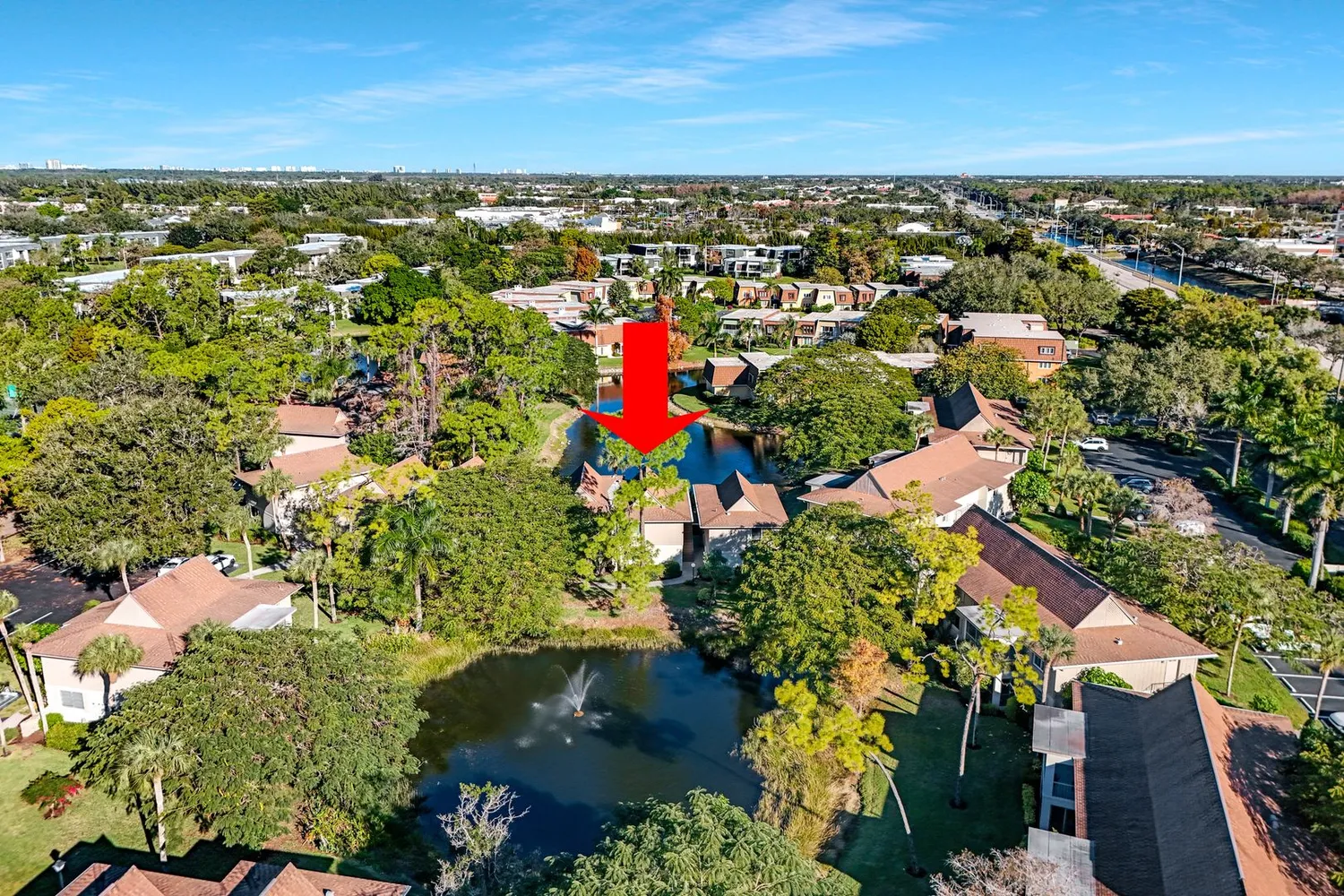 an aerial view of residential houses with outdoor space and trees