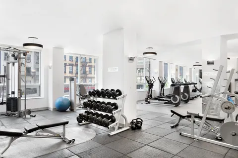 a room with gym equipment and view of living room