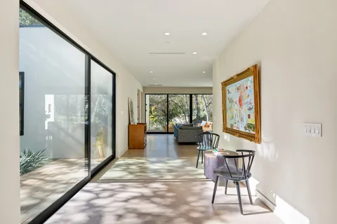 a living room with furniture and a floor to ceiling window