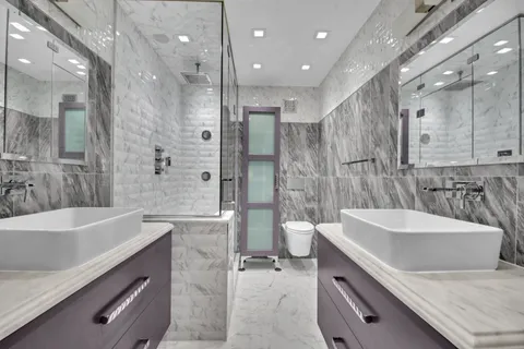 a bedroom with a bed and a potted plant