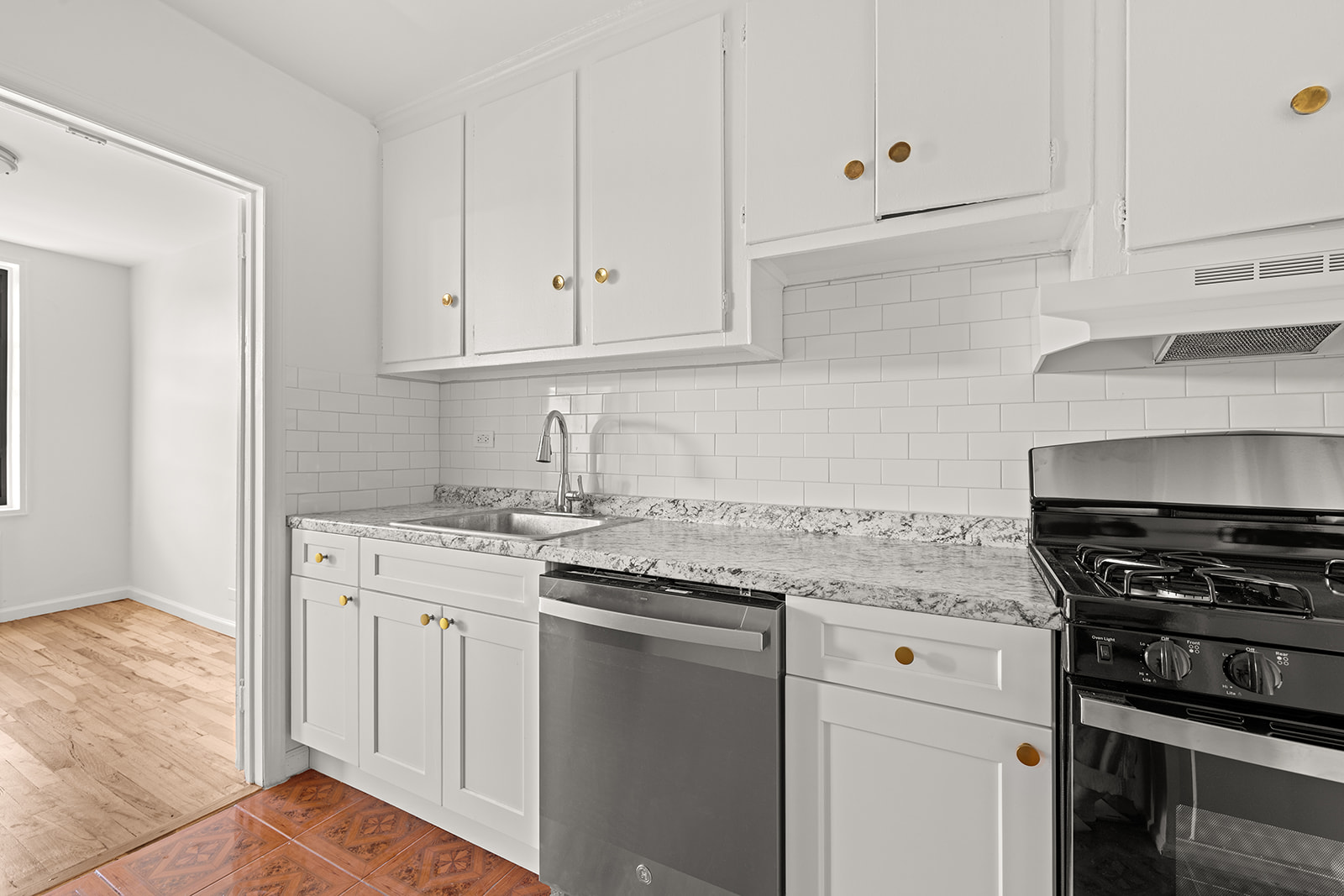 540 Ocean Parkway, Unit 5R Brooklyn, NY 11218 - Photo 9 of 11 a kitchen with granite countertop white cabinets and stainless steel appliances