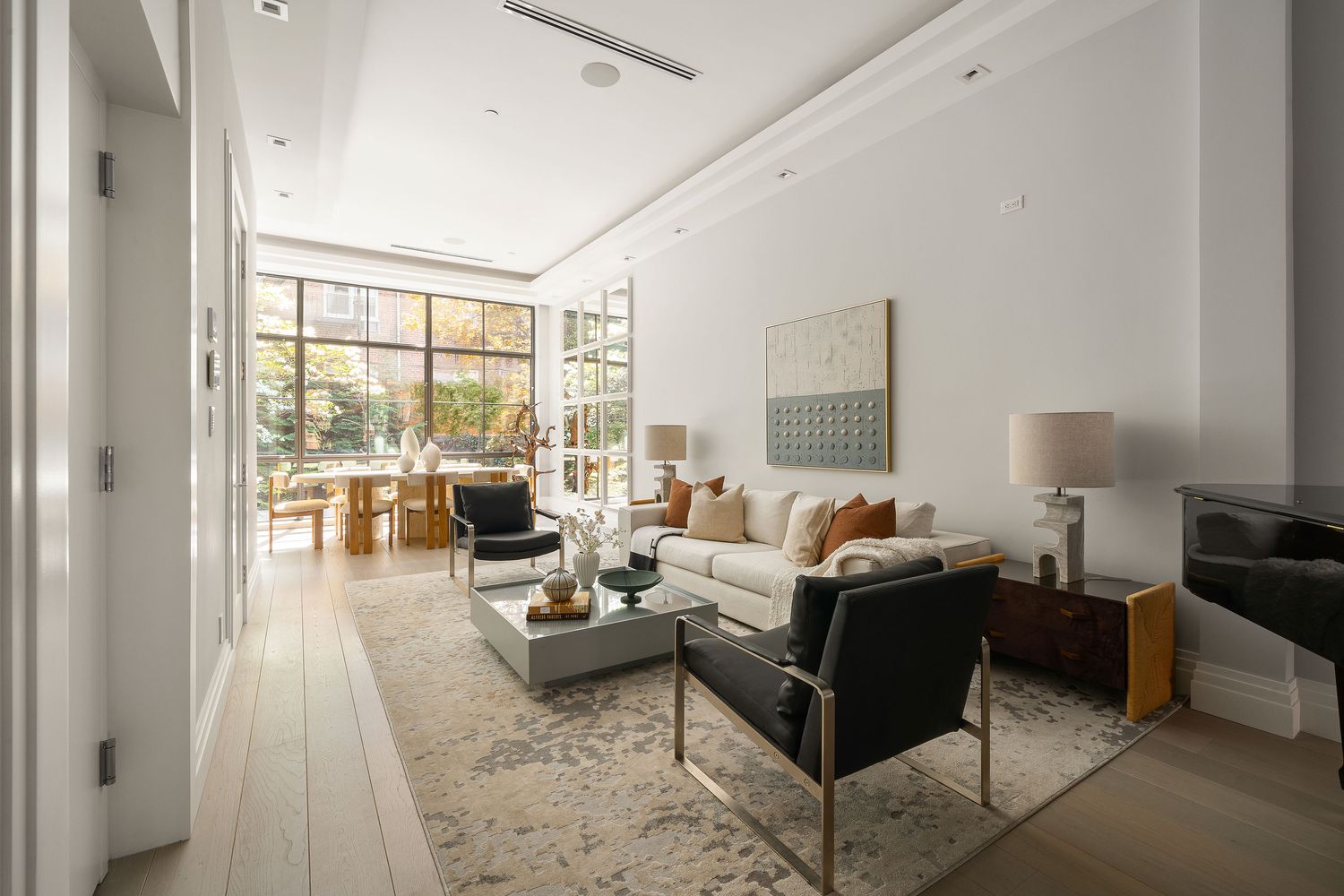 520 East 89th Street Manhattan, NY 10128 - Photo 32 of 40 a living room with furniture large window and a table