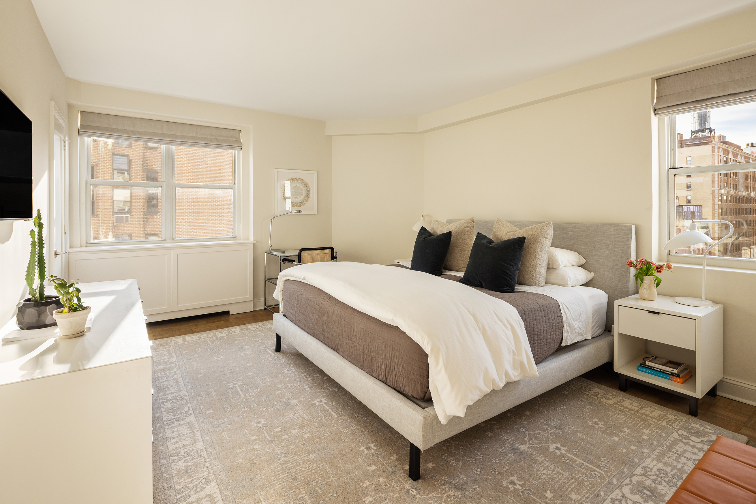 135 East 83rd Street, Unit 14B Manhattan, NY 10028 - Photo 7 of 16 a bedroom with a bed and a couch