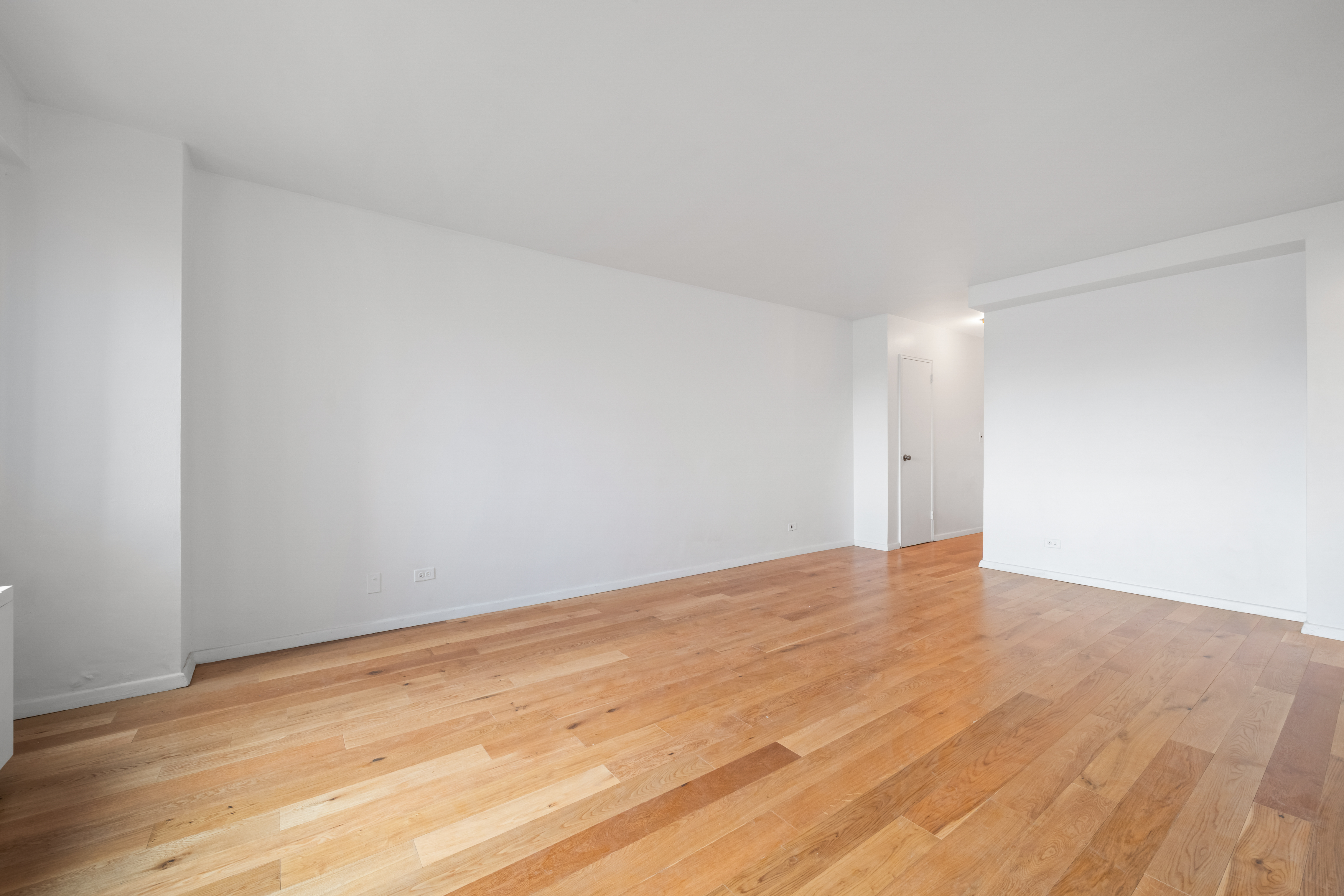 201 West 21st Street, Unit 9A Manhattan, NY 10011 - Photo 7 of 13 a view of an empty room and wooden floor