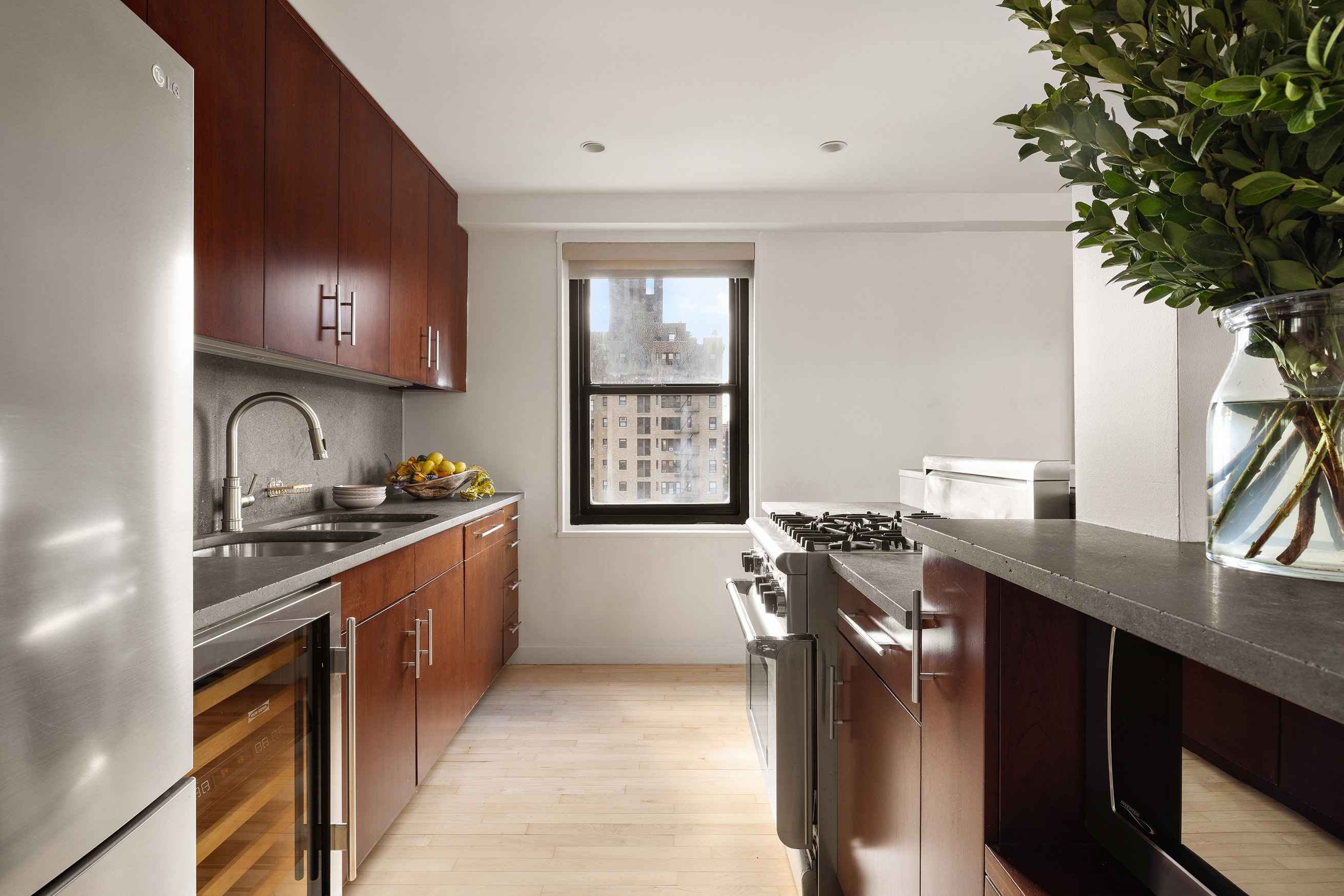 360 West 22nd Street, Unit 12B Manhattan, NY 10011 - Photo 6 of 16 a kitchen with stainless steel appliances granite countertop a stove a sink and a refrigerator