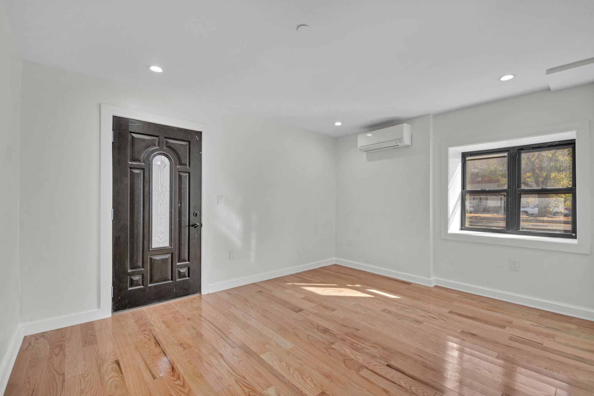 31 Roosevelt Place, Unit 1A Brooklyn, NY 11233 - Photo 5 of 14 a view of an empty room with wooden floor and a window