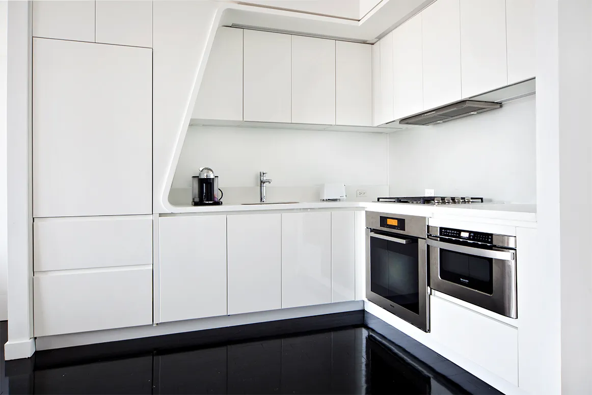 a kitchen with white cabinets and white appliances