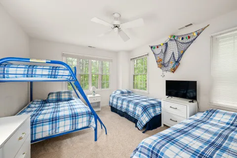 a bedroom with two beds and a flat screen tv