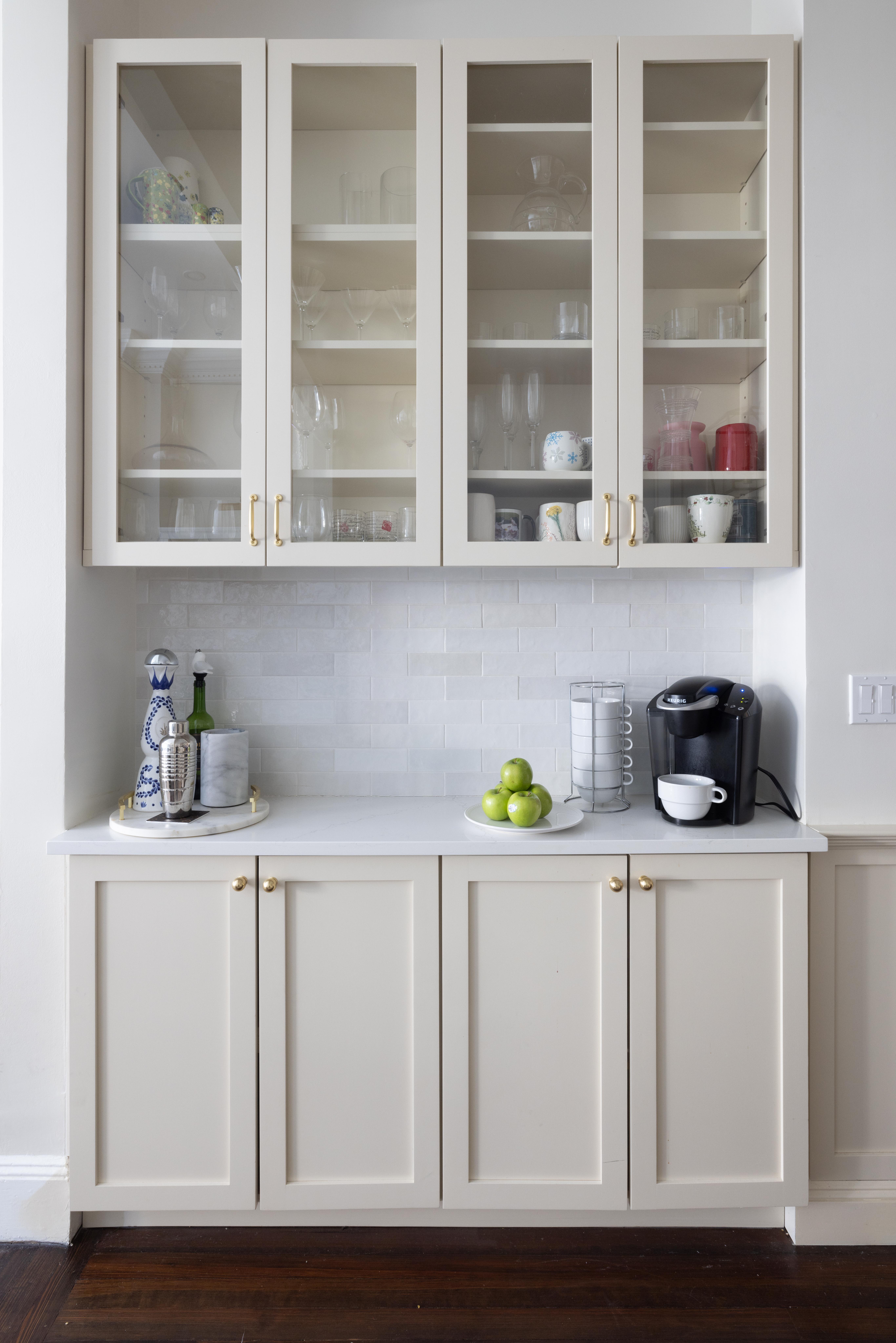 107 East 38th Street, Unit 2AB Manhattan, NY 10016 - Photo 2 of 13 a white kitchen with wooden cabinets and a sink