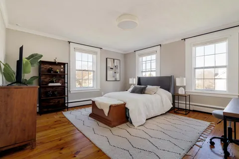 a bedroom with a bed and flat screen tv