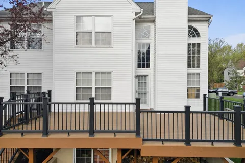 a view of a brick house with a small yard