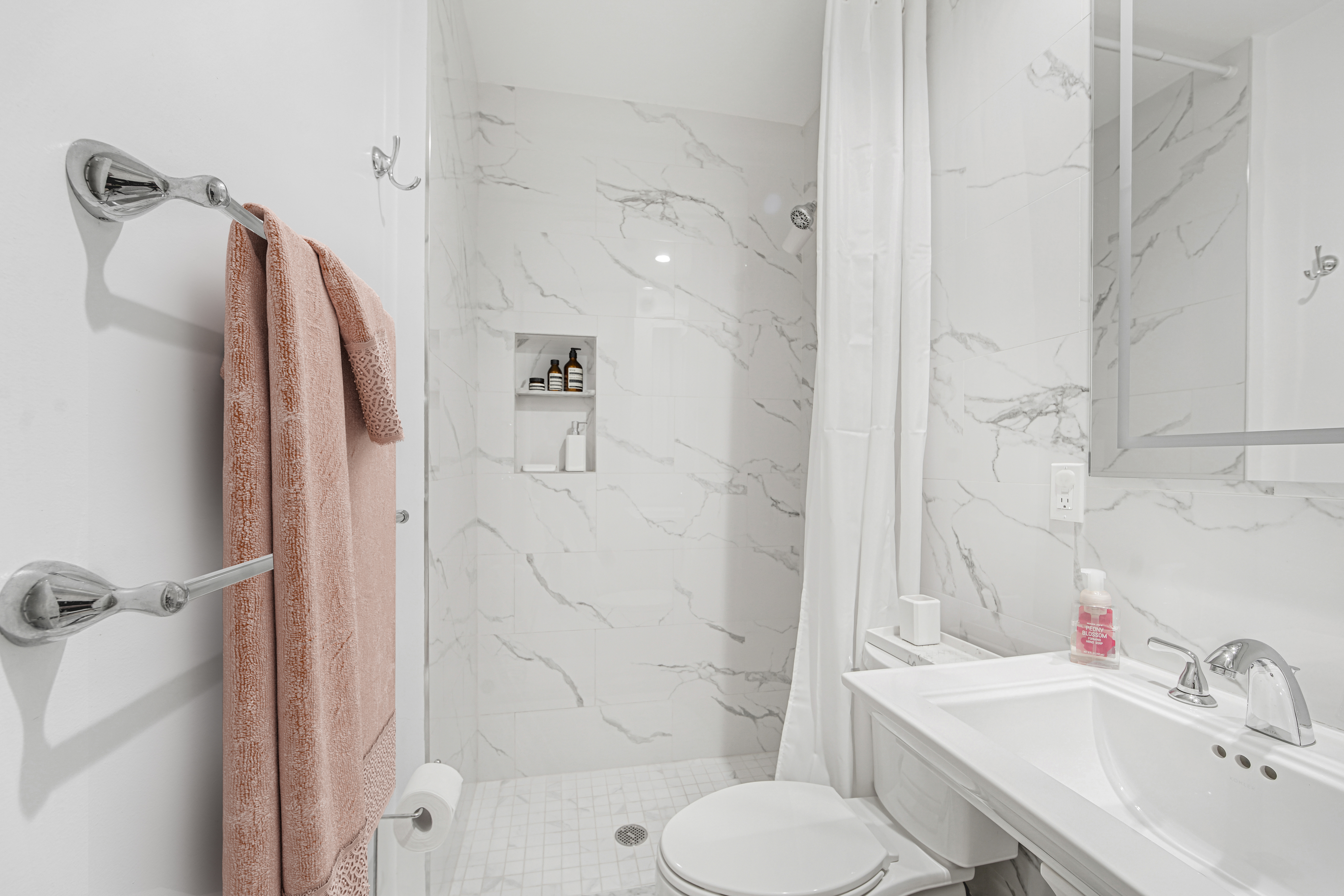 1878 Adam Clayton Powell Jr Boulevard, Unit 52 Manhattan, NY 10026 - Photo 6 of 13 a bathroom with a sink toilet and shower