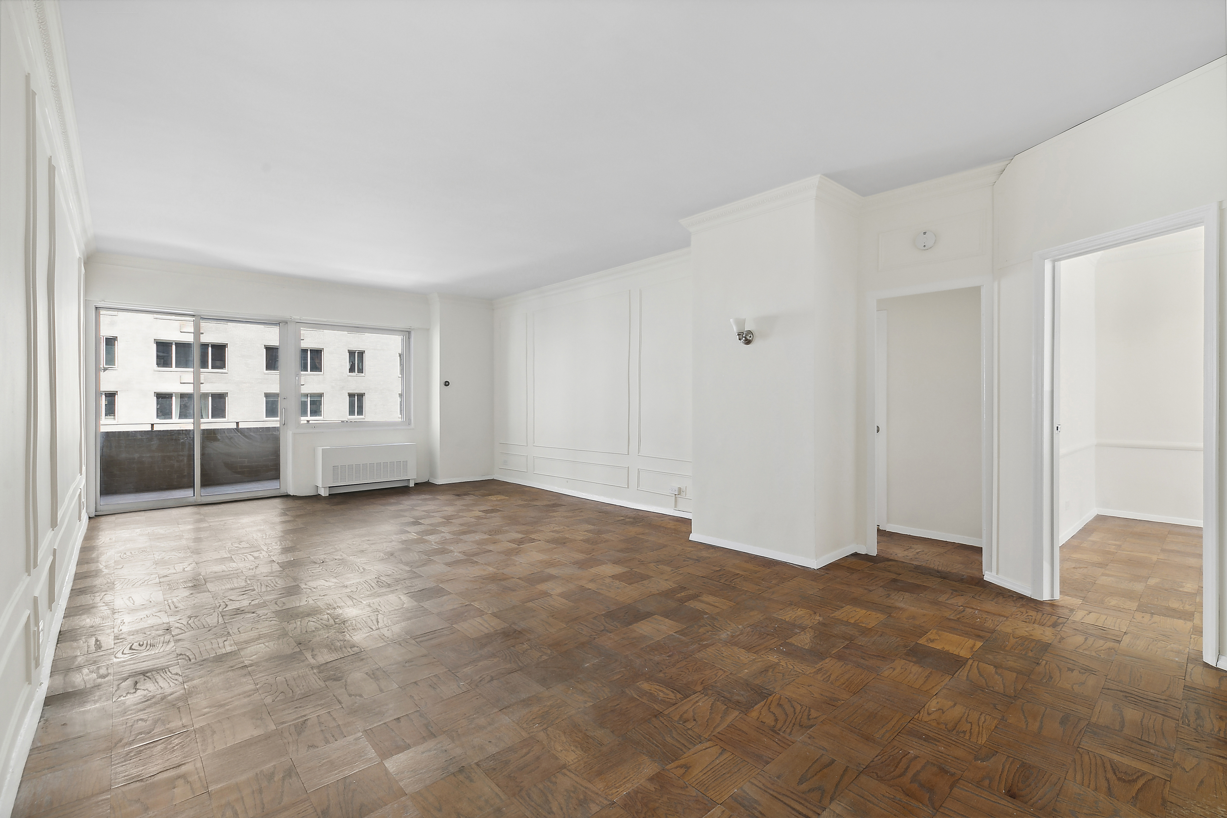 58 West 58th Street, Unit 4C Manhattan, NY 10019 - Photo 8 of 14 a view of an empty room with a window