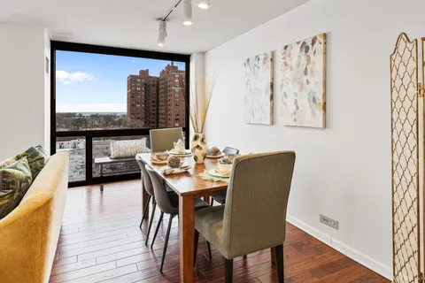 a dining room with furniture and wooden floor