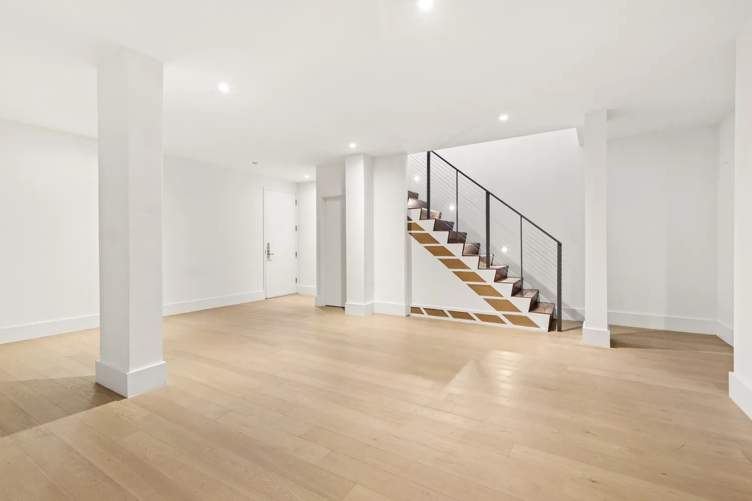 a view of an empty room with stairs