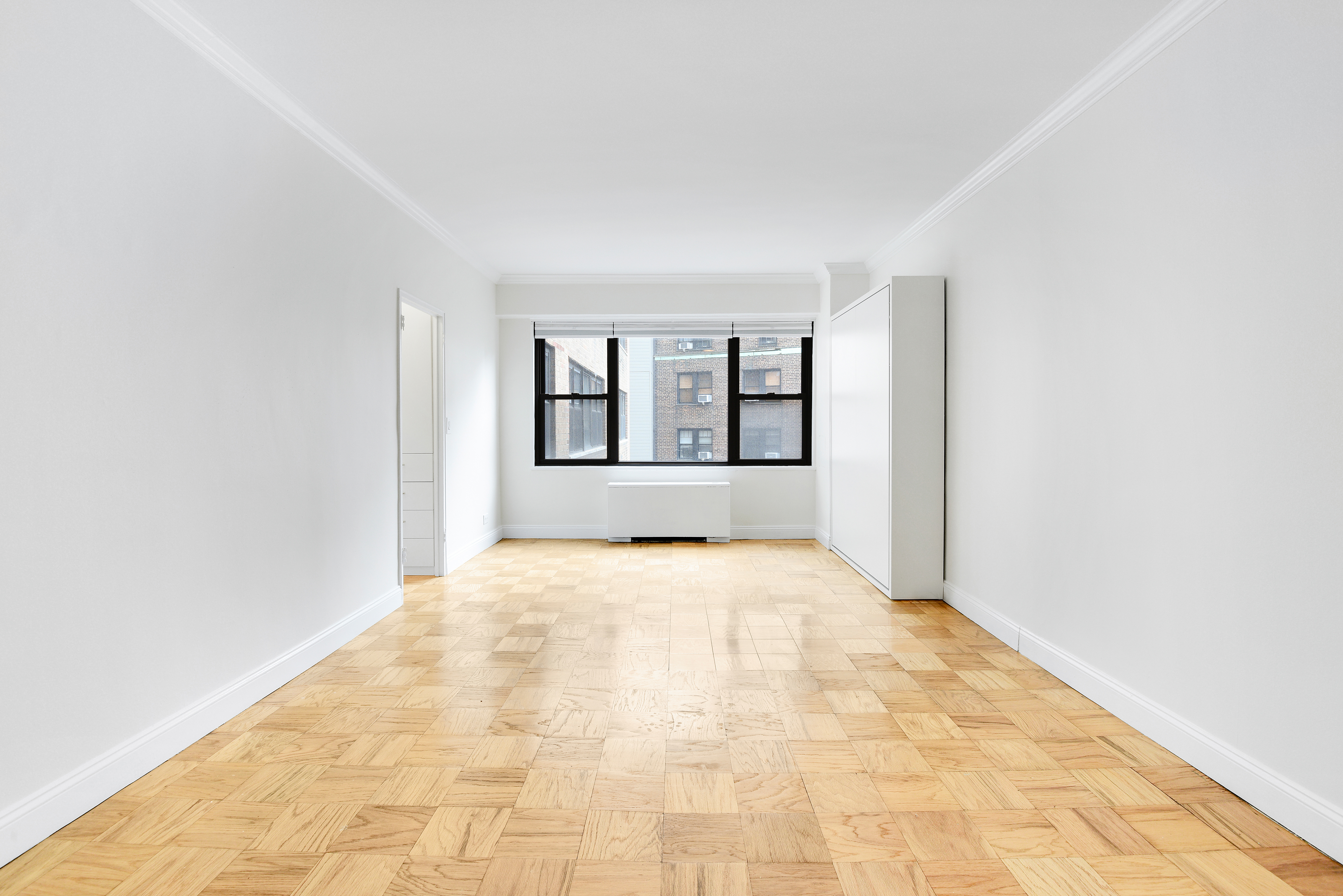 305 East 40th Street, Unit 14V Manhattan, NY 10016 - Photo 2 of 26 an empty room with windows