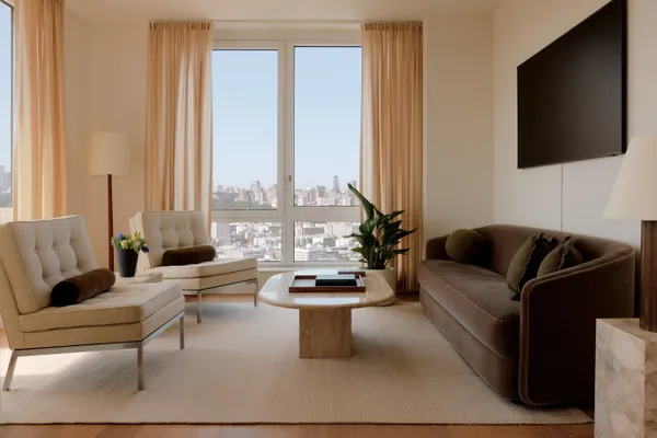 a living room with furniture a large window and a flat screen tv