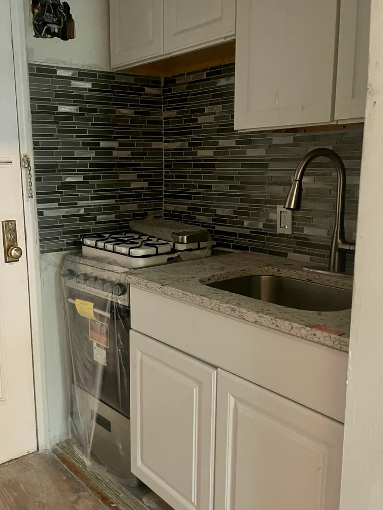 a kitchen with a stove and a sink