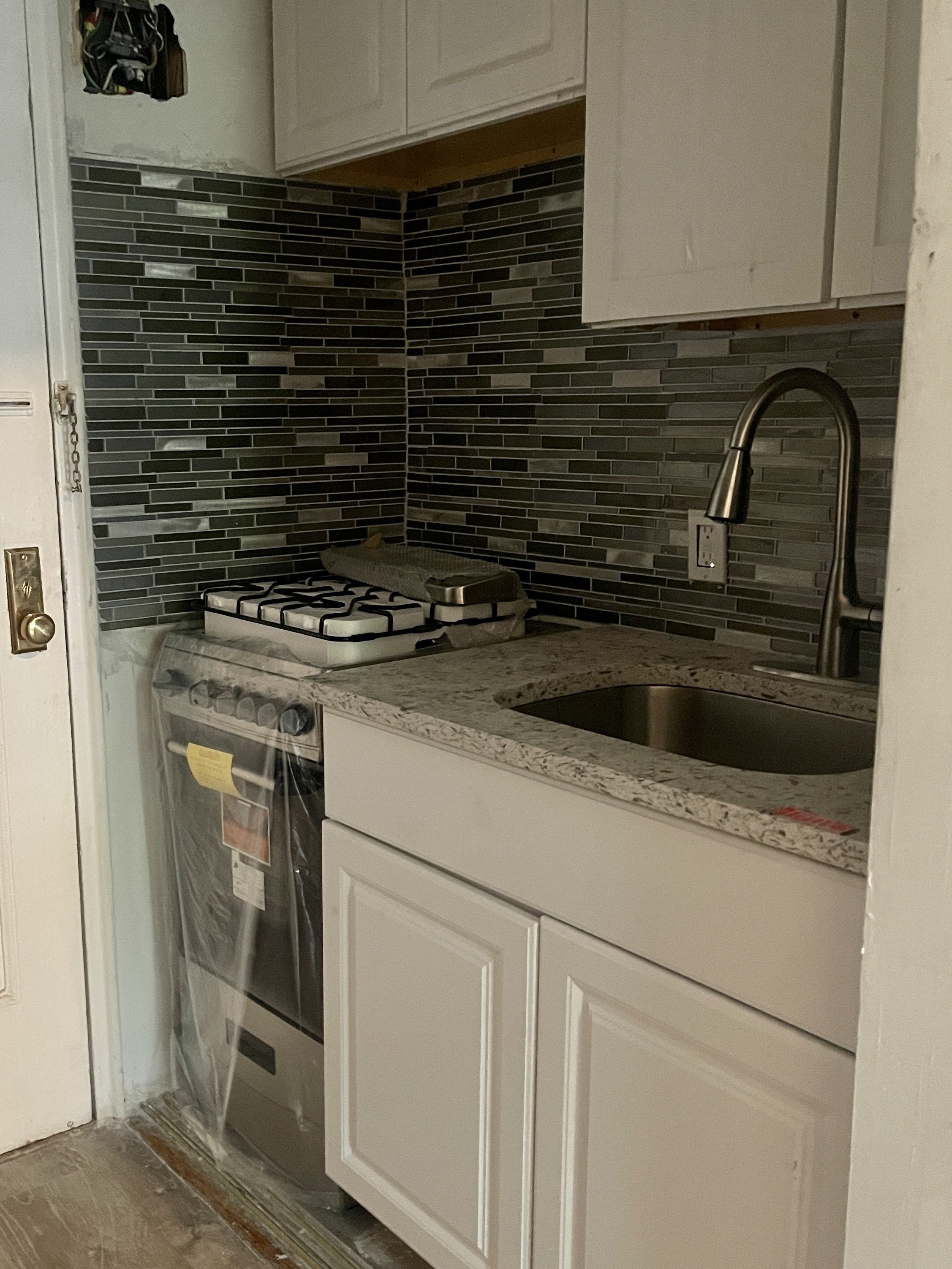611 West 145th Street Manhattan, NY 10031 - Photo 4 of 8 a kitchen with a stove and a sink