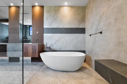 a bathroom with a bathtub and shower