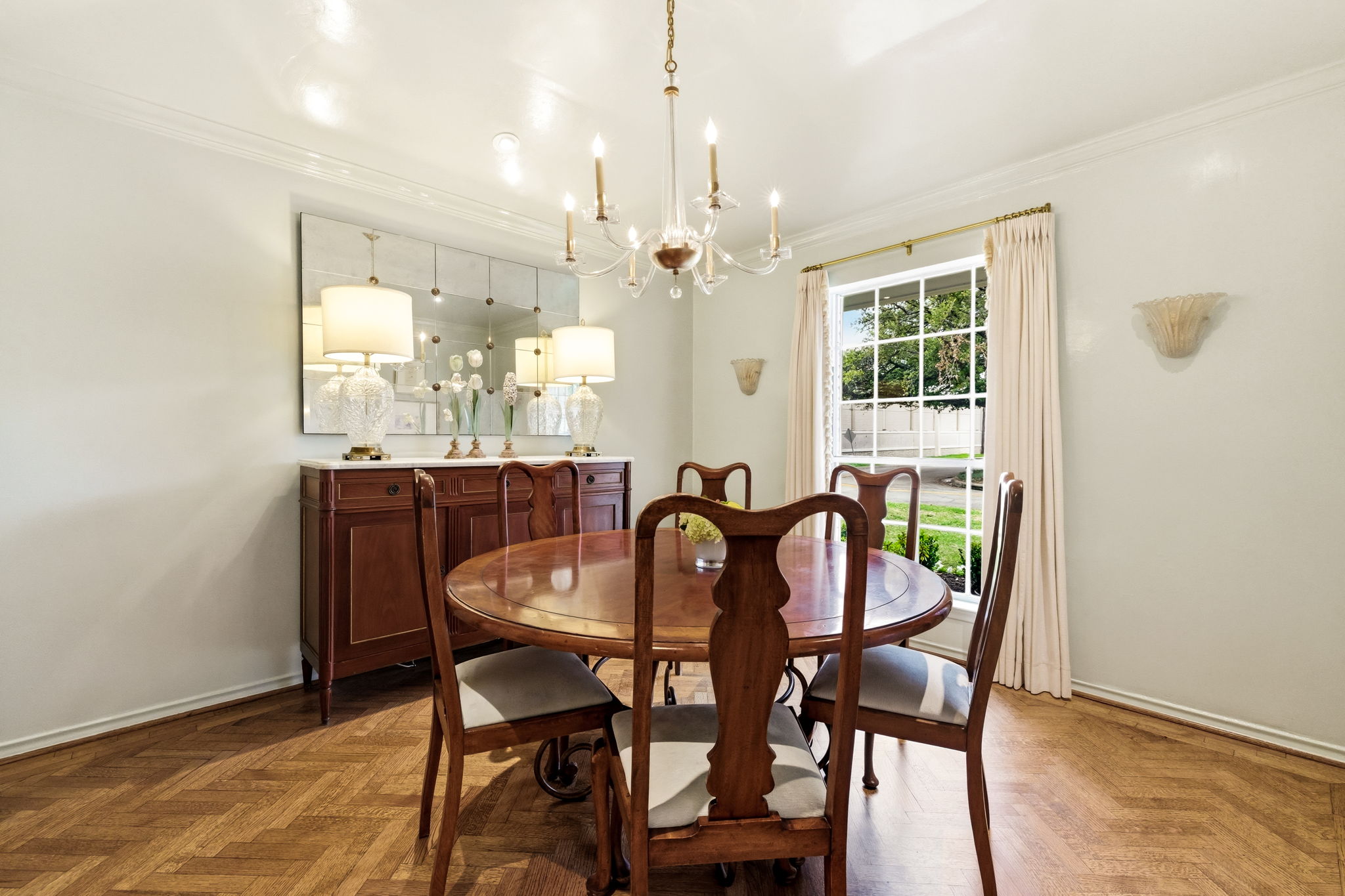 5765 Stonegate Road Dallas, TX 75209 - Photo 8 of 37 a view of a dining room with furniture and a chandelier