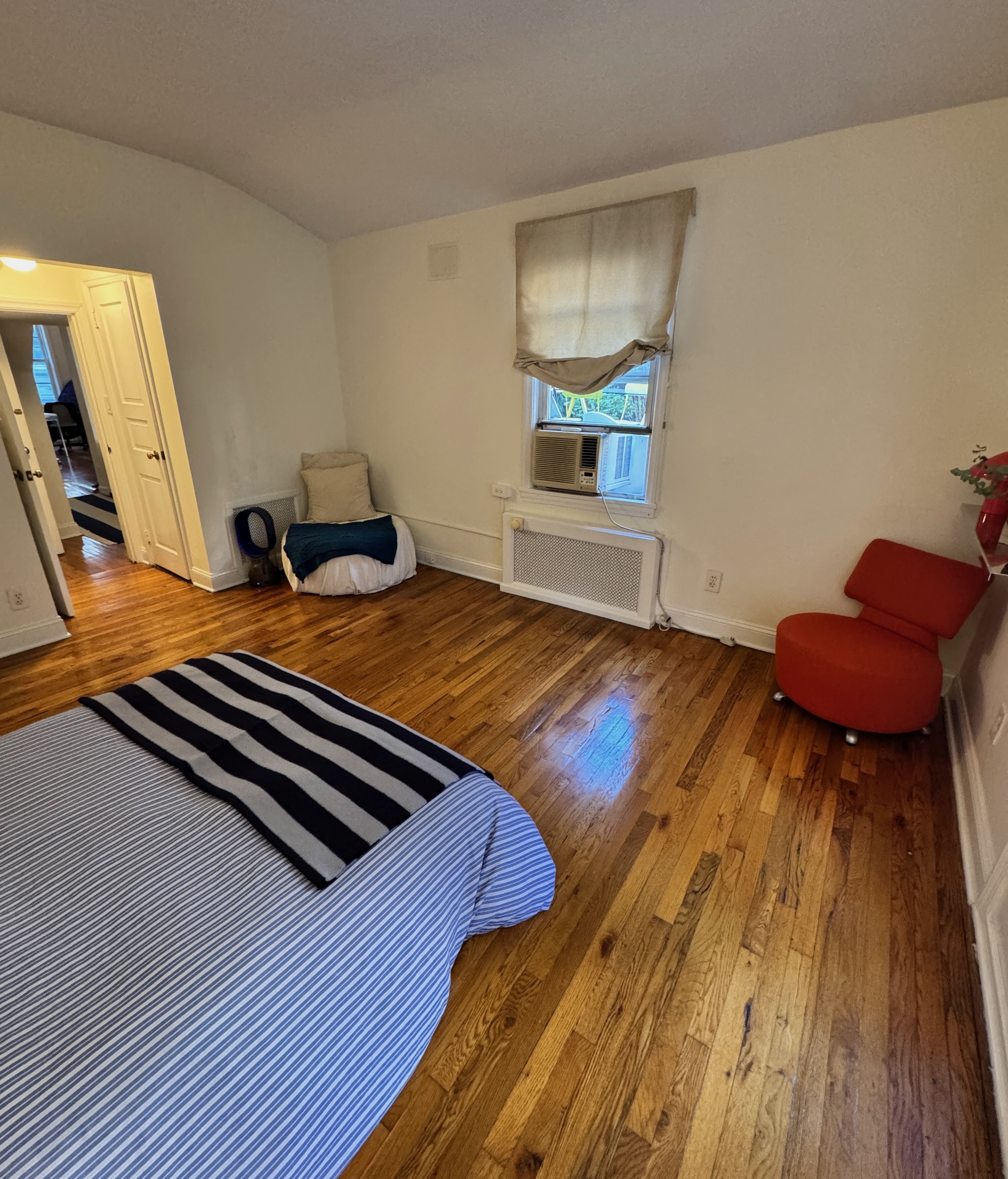 19 Vandam Street, Unit 2 Manhattan, NY 10014 - Photo 11 of 19 a bedroom with a bed and wooden floor