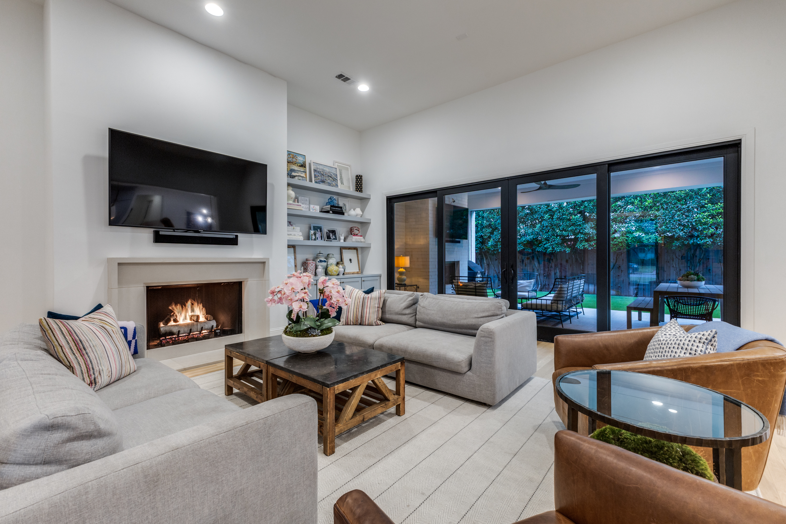 4042 Dunhaven Road Dallas, TX 75220 - Photo 9 of 34 a living room with furniture a flat screen tv and a fireplace