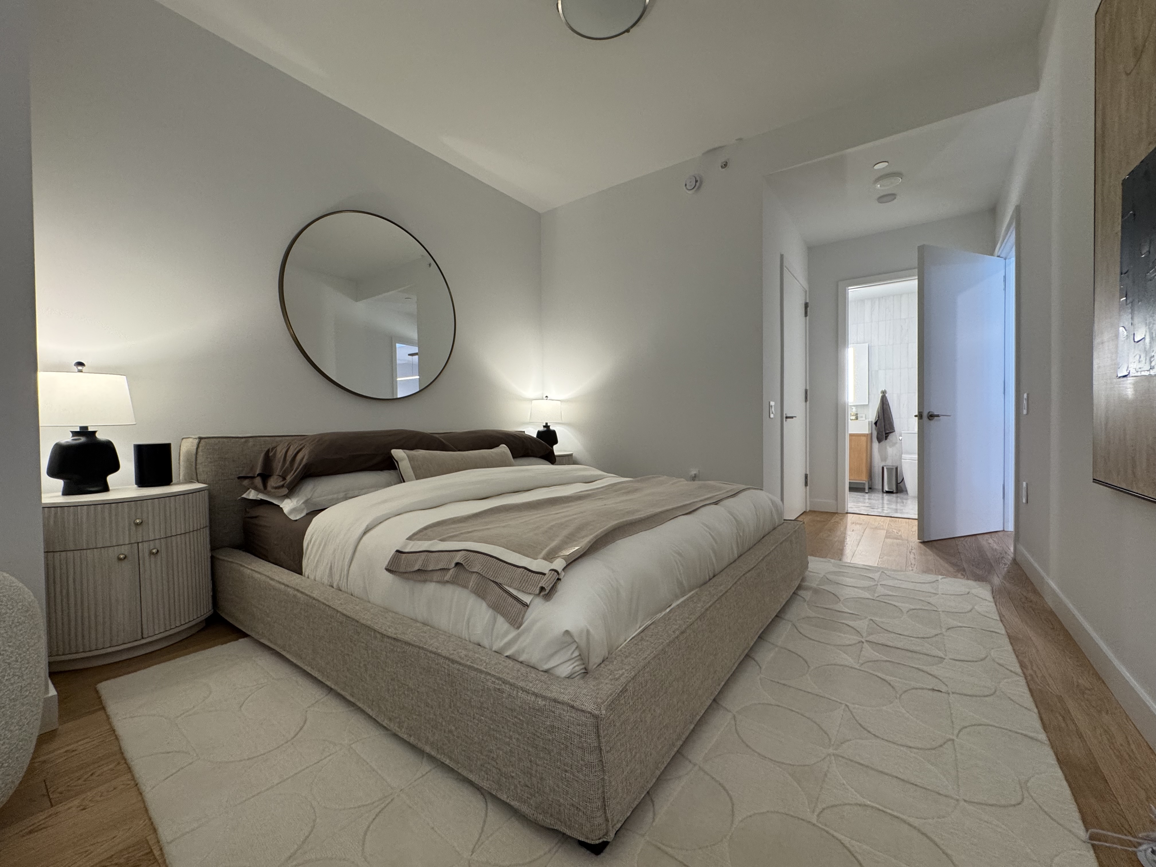 18 West 55th Street, Unit 7B Manhattan, NY 10019 - Photo 12 of 20 a bed room with a bed and mirror