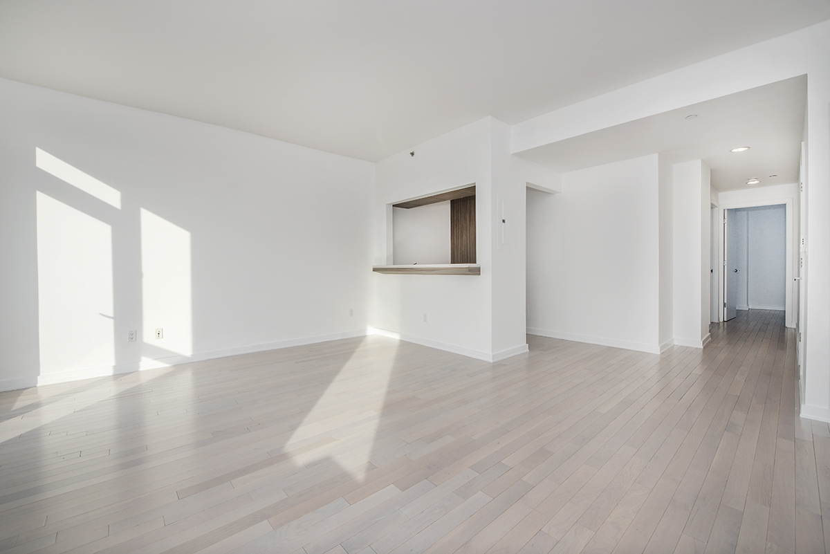 250 Bedford Avenue, Unit 129203 Brooklyn, NY 11249 - Photo 2 of 10 a view of an empty room with wooden floor and a window