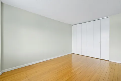 a bathroom with a sink a toilet a mirror a bathtub and shower