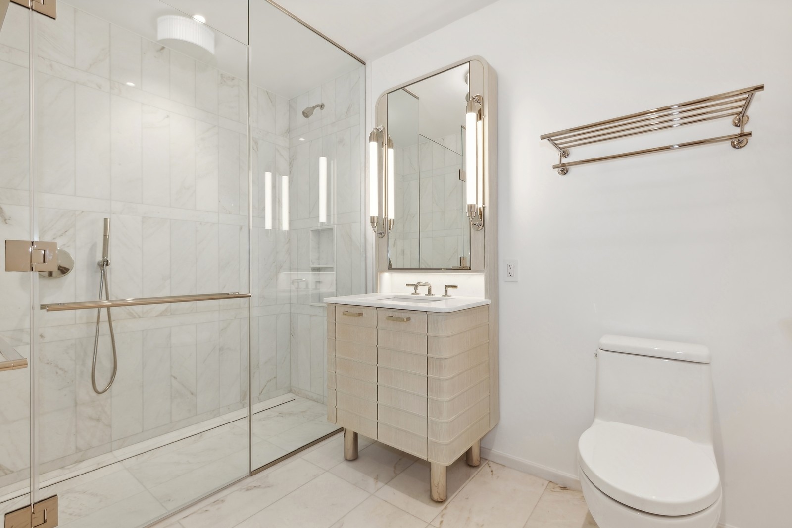249 East 62nd Street, Unit 5C Manhattan, NY 10065 - Photo 4 of 9 a bathroom with a shower sink mirror and toilet
